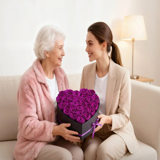 Two women holding a heart-shaped box of purple roses with text about lasting love and rose longevity.