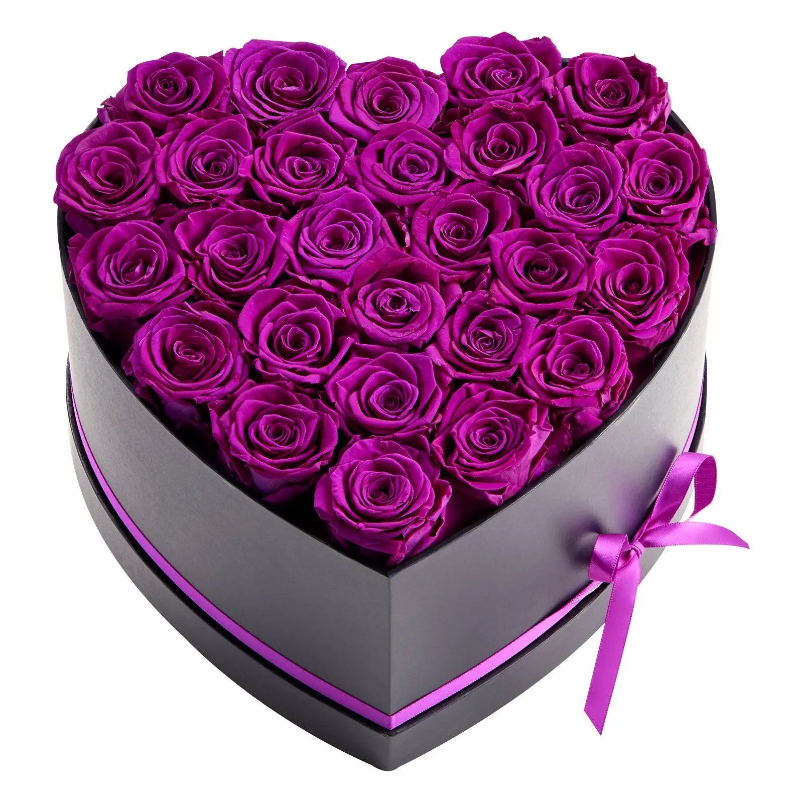 A heart-shaped black gift box filled with preserved deep purple roses, tied with a matching purple ribbon, on a plain white background.