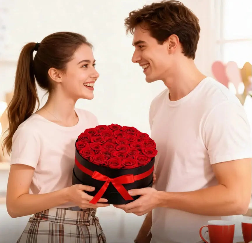 Couple exchanging a large bouquet of red roses wrapped in black paper and red ribbon.